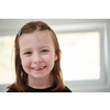 Funny little girl without tooth smiles showing gap close up