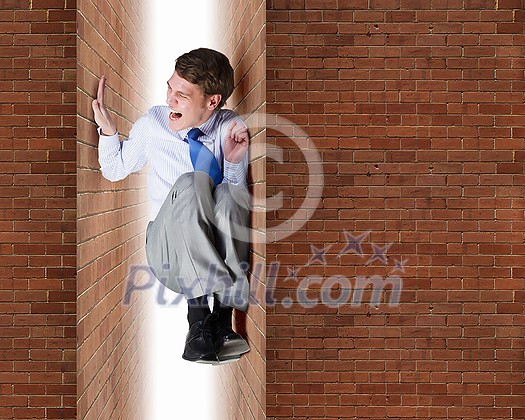 Businessman under pressure between two stone walls Businessman under pressure between two stone walls
