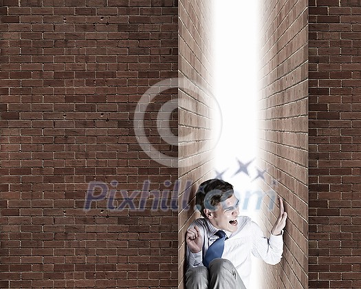 Businessman under pressure between two stone walls