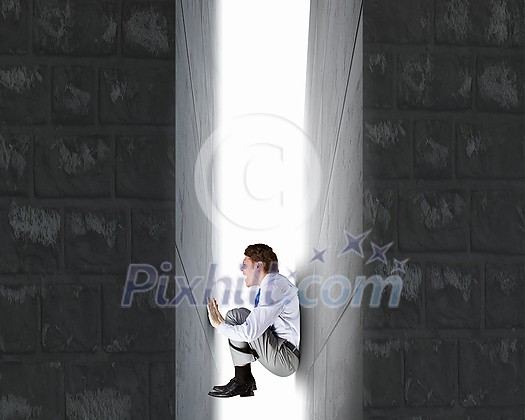 Businessman under pressure between two stone walls Businessman under pressure between two stone walls