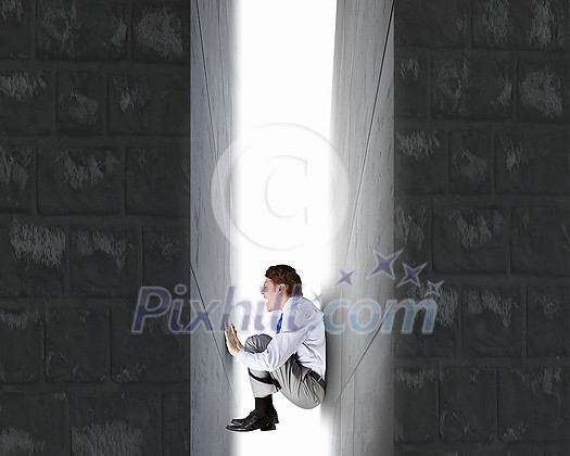 Businessman under pressure between two stone walls