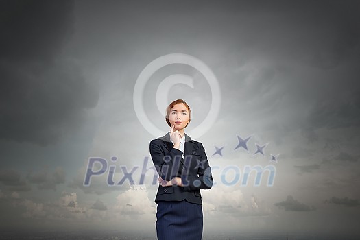Young thoughtful businesswoman with finger on chin Young thoughtful businesswoman with finger on chin