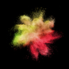 Creative chaotic powder explosion or splash in yellow and red colors on a black background with copy space.