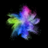 Creative chaotic multicolored powder explosion or splash on a black background with copy space.