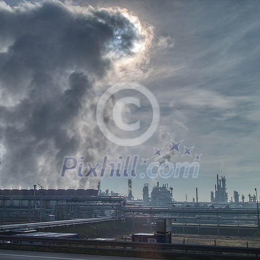 Dramatic cloudy sky with fumes atmosphere industrial emission above huge power station or plant in Budapest, Hungary. Dramatic cloudy sky with fumes atmosphere industrial emission above huge power station or plant in Budapest, Hungary.