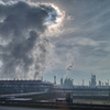 Dramatic cloudy sky with fumes atmosphere industrial emission above huge power station or plant in Budapest, Hungary.