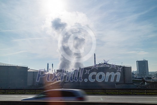 Industrial huge construction of large power station or plant with strong atmosphere industrial emission above it on a background of cloudy sunny sky in Budapest, Hungary. Industrial huge construction of large power station or plant with strong atmosphere industrial emission above it on a background of cloudy sunny sky in Budapest, Hungary.