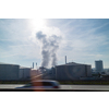 Industrial huge construction of large power station or plant with strong atmosphere industrial emission above it on a background of cloudy sunny sky in Budapest, Hungary.