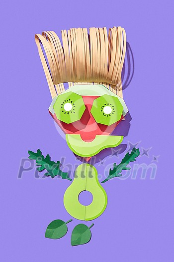 Handmade from colorful paper little man made from papercraft fruits and vegetables on a purple background with shadows, copy space. Vegan healthy food.