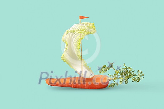 Creative vegetarian boat handmade from fresh natural organic vegetables carrot and leaf of bok choy on a pastel turquoise background, copy space. Creative vegetarian boat handmade from fresh natural organic vegetables carrot and leaf of bok choy on a pastel turquoise background, copy space.