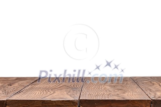 Empty wooden deck table against white wallpaper background for present product. Can be used for your creativity. Empty wooden deck table against white wallpaper background for present product. Can be used for your creativity.