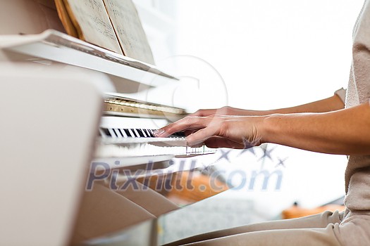 Playing Piano (shallow DOF; color toned image) Playing Piano (shallow DOF; color toned image)