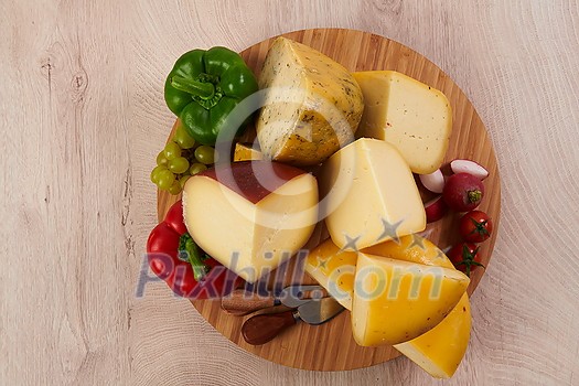Organic Cheese healthy gourment food produced on local farm assortment on wooden background Organic Cheese healthy gourment food produced on local farm assortment on wooden background