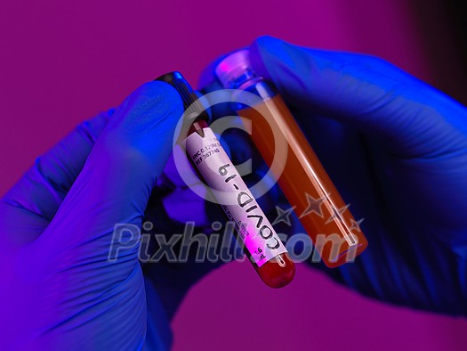 Coronavirus, Doctor holding positive covid-19 virus Blood Sample tube and medicine cure drug