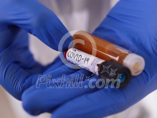 Coronavirus, Doctor holding positive covid-19 virus Blood Sample tube and medicine cure drug