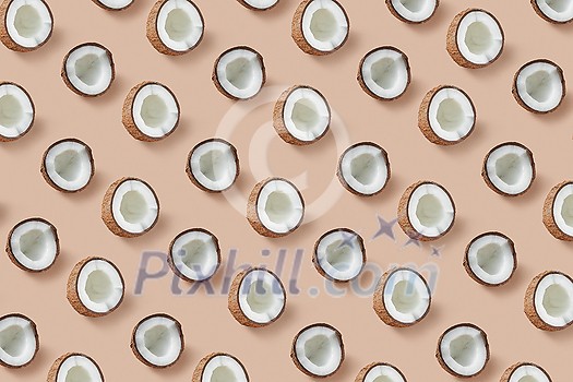 Creative fruits pattern from natural organic tropical coconut's halves on a beige background. Flat lay. Vegan concept. Creative fruits pattern from natural organic tropical coconut's halves on a beige background. Flat lay. Vegan concept.