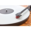 Vintage old-fashioned turnable record player with retro vinil disc on a wooden table, copy space. Close up view. Popular disco trends 60s, 70s, 80s, 90s.