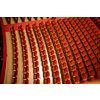 View of the empty parterre in the theatre concert hall of Vienna State Opera auditorium with red seats in the rows without people in Vienna, Austria.