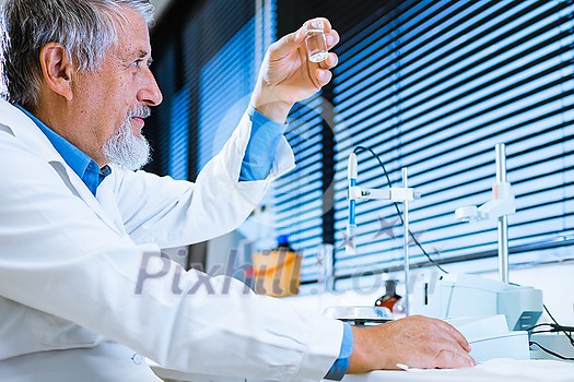 Senior male researcher carrying out scientific research in a lab (shallow DOF; color toned image) Senior male researcher carrying out scientific research in a lab (shallow DOF; color toned image)
