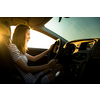 Driving a car at night - pretty, young woman driving her modern car (shallow DOF; color toned image)