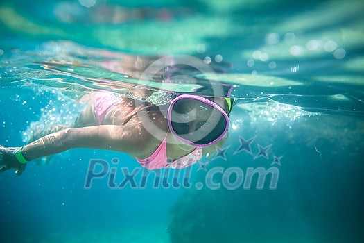 LIttle girl swimming underwater in the sea, enjoying summer fully LIttle girl swimming underwater in the sea, enjoying summer fully