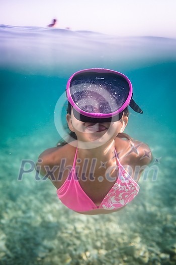 LIttle girl swimming underwater in the sea, enjoying summer fully LIttle girl swimming underwater in the sea, enjoying summer fully