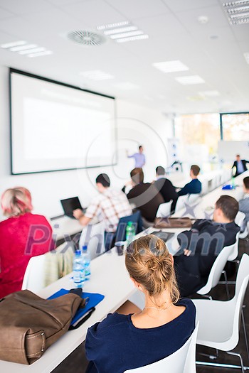 People in a conference room listening to a speech People in a conference room listening to a speech
