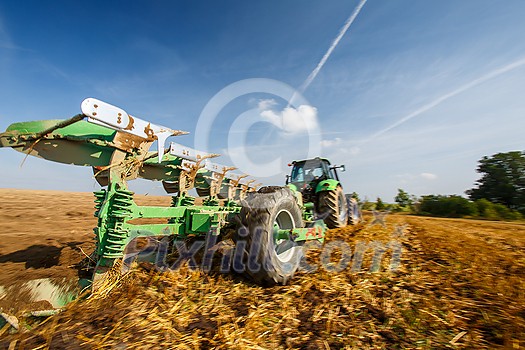 Tractor working on the farm, modern agricultural transport, farmer working in the field, tractor on a sunset background, cultivation of land, agricultural machine Tractor working on the farm, modern agricultural transport, farmer working in the field, tractor on a sunset background, cultivation of land, agricultural machine
