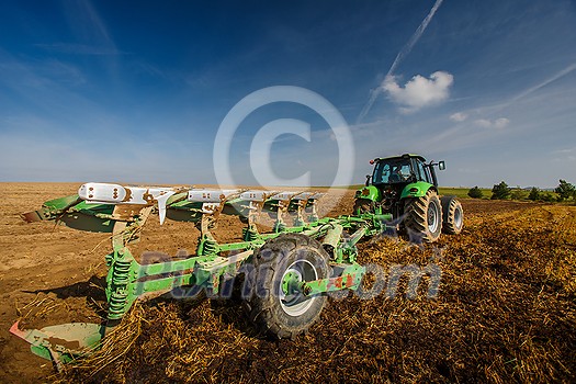 Tractor working on the farm, modern agricultural transport, farmer working in the field, tractor on a sunset background, cultivation of land, agricultural machine Tractor working on the farm, modern agricultural transport, farmer working in the field, tractor on a sunset background, cultivation of land, agricultural machine