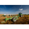 Tractor working on the farm, modern agricultural transport, farmer working in the field, tractor on a sunset background, cultivation of land, agricultural machine