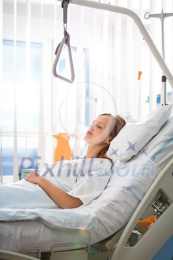 Pretty, young, female patient in a modern hospital room. Getting better fast after a surgery - pensive yet positive, thinking ahead, making plans (shallow DOF; color toned image) Pretty, young, female patient in a modern hospital room. Getting better fast after a surgery - pensive yet positive, thinking ahead, making plans (shallow DOF; color toned image)