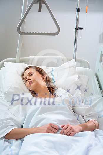 Pretty, young female patient in a modern hospital room. Getting better fast after a surgery (shallow DOF; color toned image) Pretty, young female patient in a modern hospital room. Getting better fast after a surgery (shallow DOF; color toned image)