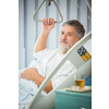 Senior male patient in a modern hospital. Getting better after a surgery/illness (shallow DOF; color toned image)