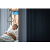 Senior male patient in a modern hospital. Getting better after a surgery/illness (shallow DOF; color toned image)