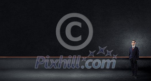 Young businessman in glasses and blank blackboard Young businessman in glasses and blank blackboard