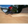 Bmx rider jumping over on a U ramp in a skatepark (motion blurred image)
