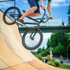 Bmx rider jumping over on a U ramp in a skatepark (motion blurred image)