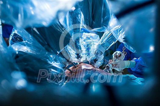 Surgery in a modern hospital being performed by a team of professionals (shallow DOF, color toned image) Surgery in a modern hospital being performed by a team of professionals (shallow DOF, color toned image)
