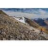 Pretty, young female hiker going uphill in beautiful highlands of Scotland