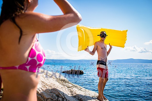 Young man having fun and taking a dive in the sea