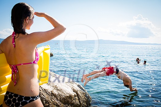 Young man having fun and taking a dive in the sea Young man having fun and taking a dive in the sea