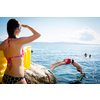 Young man having fun and taking a dive in the sea