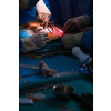 Surgery in a modern hospital being performed by a team of professionals (shallow DOF, color toned image)