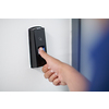 man pressing fingerprint scanner on alarm system indoors
Finger print scan for unlock door security system