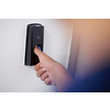 man pressing fingerprint scanner on alarm system indoors
Finger print scan for unlock door security system