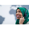 African muslim female with green hijab scarf customer representative business woman with phone headset helping and supporting online with customer in modern call centre
