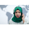 African muslim female with green hijab scarf customer representative business woman with phone headset helping and supporting online with customer in modern call centre