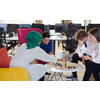 multiethnic group of business people playing chess while having a break in relaxation area at modern startup office