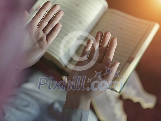 muslim man praying Allah alone inside the mosque and reading islamic holly book quran