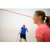 Squash players in action on a squash court (motion blurred image; color toned image)